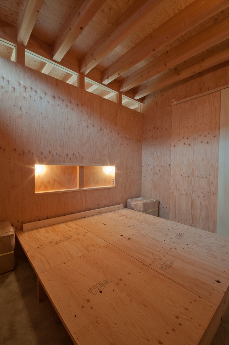 神戸町の家　寝室の壁は構造用合板、床はコンクリートの土間。置かれた構造用合板はベッドのマットを敷きます
